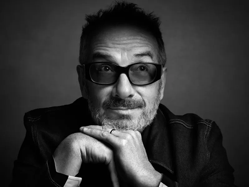 Image: A black and white picture of Elvis Costello posing