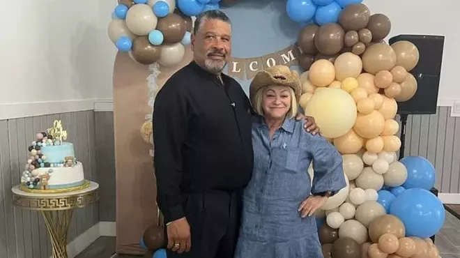 Sonia Bichara (right) and Rafael Collodo pose for a picture in front of balloons