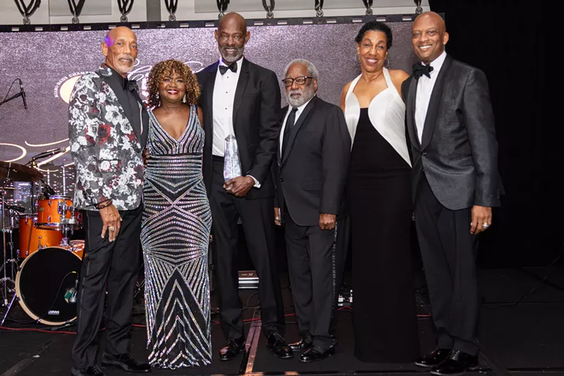 Image: From left to right: Eric Knowles, Lynda Harris, Dr. Willie Logan, H.T. Smith, Teri Williams, and Commissioner Oliver G. Gilbert, III pose together on stage in formal attire during the Miami-Dade Chamber of Commerce’s gala.