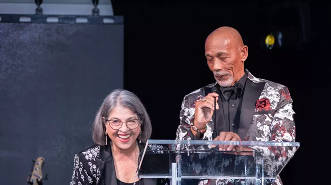 Eric Knowles and Mayor Daniella Levine Cava at a podium during the Miami-Dade Chamber of Commerce’s gala