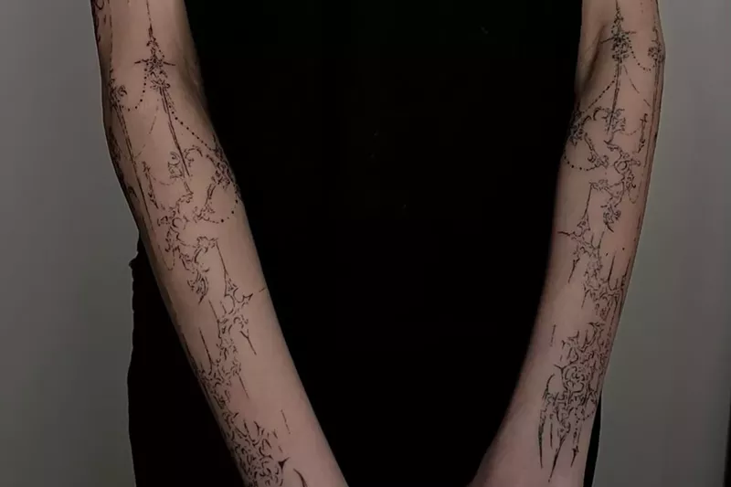 Image: Arms tattooed with a cybersigilism design