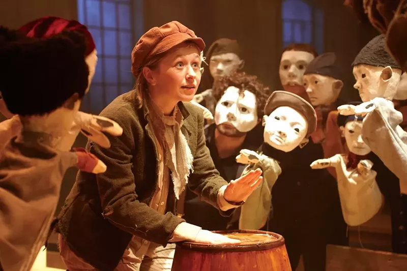 Image: Hallie Walker on stage as Oliver singing with Fagin's boys