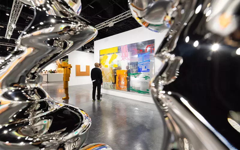 Image: A man staring at a painting at Art Basel Miami Beach
