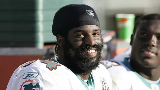Miami Dolphins running back Ricky Williams smiles on the sidelines as the Miami Dolphins defeat the Oakland Raiders 33–21 at McAfee Coliseum, Oakland, California, November 27, 2005