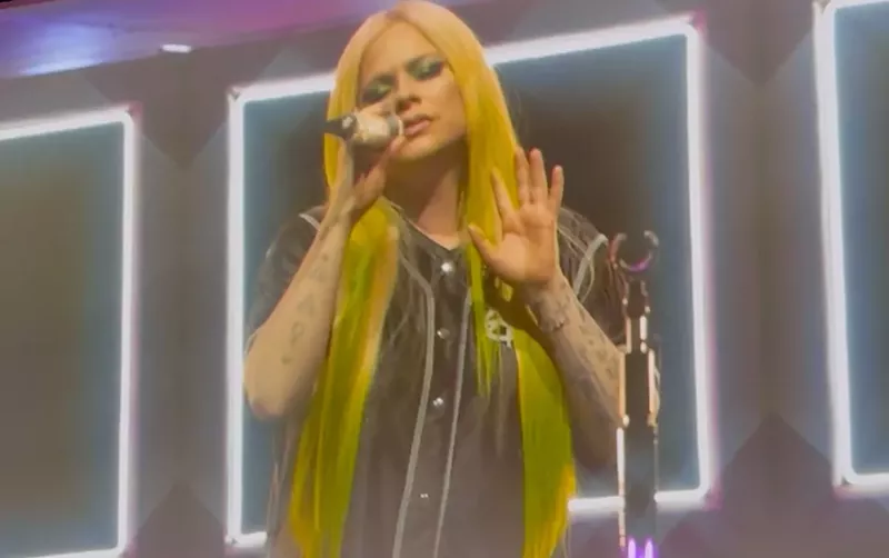 Image: Avril Lavigne sings into a microphone onstage