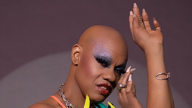 Portrait of Kevin Aviance with heavy makeup and long nails