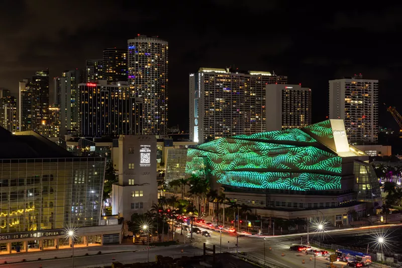 Image: colorful art projection is projected onto a building in downtown Miami