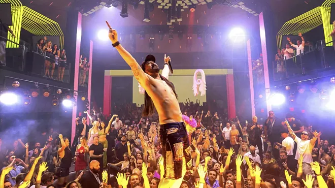 Picture of steve Aoki on stage in front of a crowd