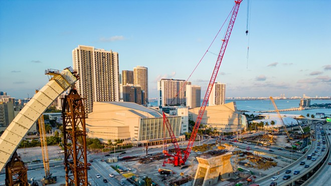 Highway traffic flowing in downtown Miami near a massive construction project