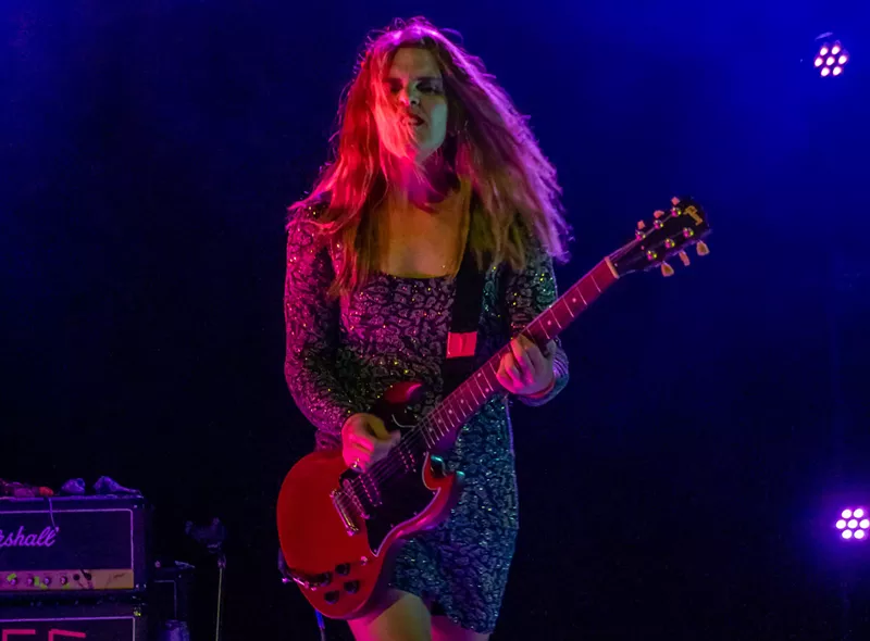 Image: Erica Dawn Lyle performing with Bikini Kill at the Greek Theater in Los Angeles in April 2022.
