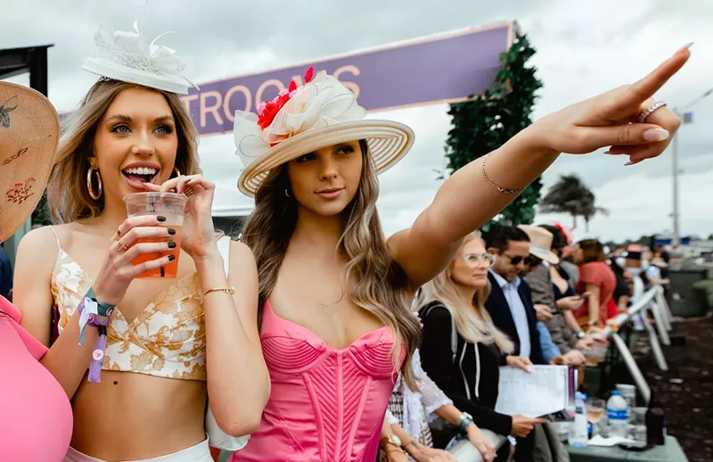 Image: Two women standing trackside at the Pegasus World Cup in Hallandale Beach, Florida