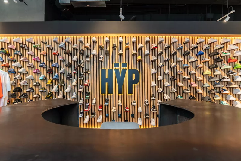 Image: Wall display of colorful sneakers and the Hÿp logo inside the flagship store at Miami Worldcenter
