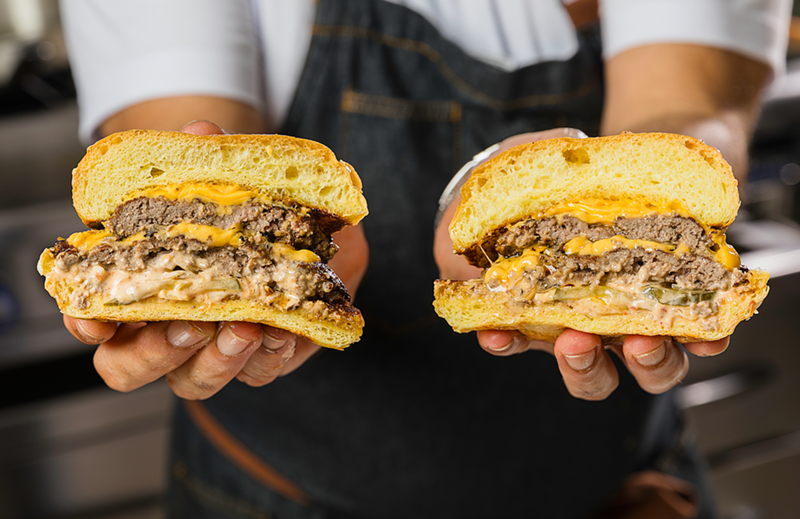 Celia's smash burgers opens in Wynwood, Miami with cheesy wagyu burgers made with marinated onions, pickle, and special sauce and a side