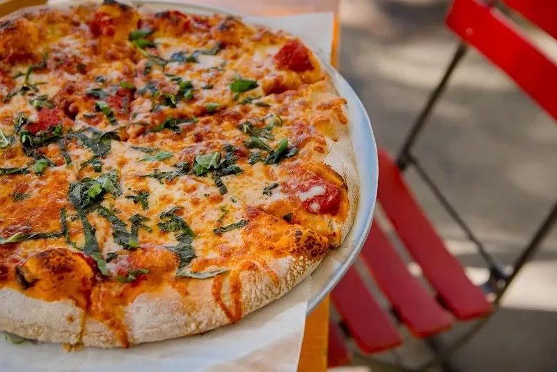 Image: Longtime Miami pizzeria Andiamo Brick Oven Pizza will close this fall in 2025 at its historic location at the General Tire Building at 5600 Biscayne Blvd.
