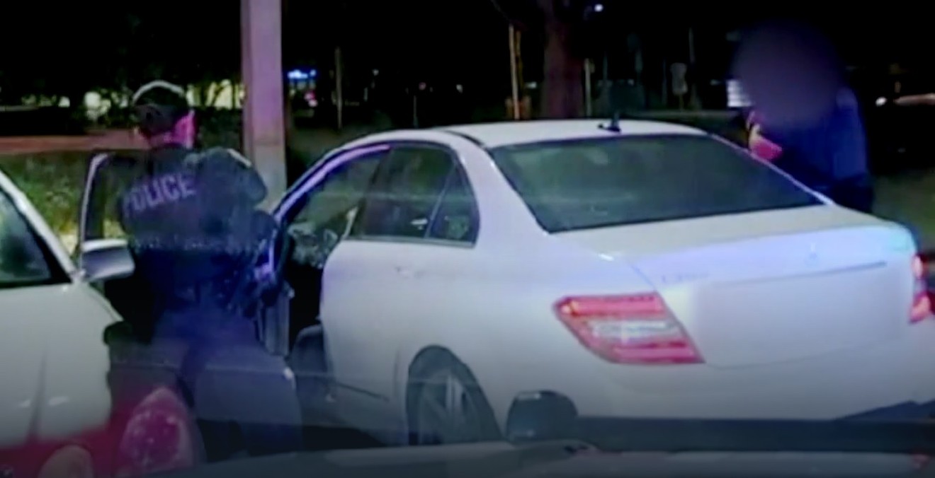 Police have their guns drawn on Brittni Muldrew moments before she backs up the vehicle during the August 2021 encounter.