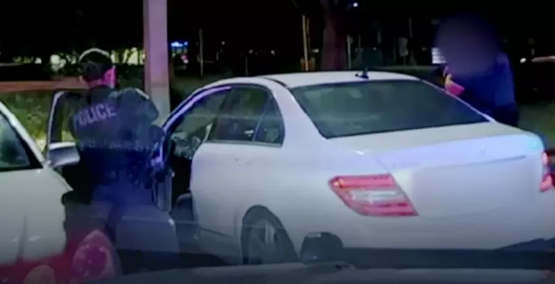 Image: Police have their guns drawn on Brittni Muldrew moments before she backs up the vehicle during the August 2021 encounter.