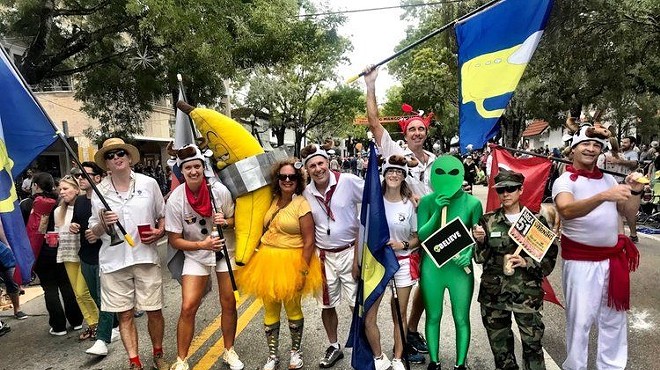 Participants in the King Mango Strut Parade in Coconut Grove line the street in costume
