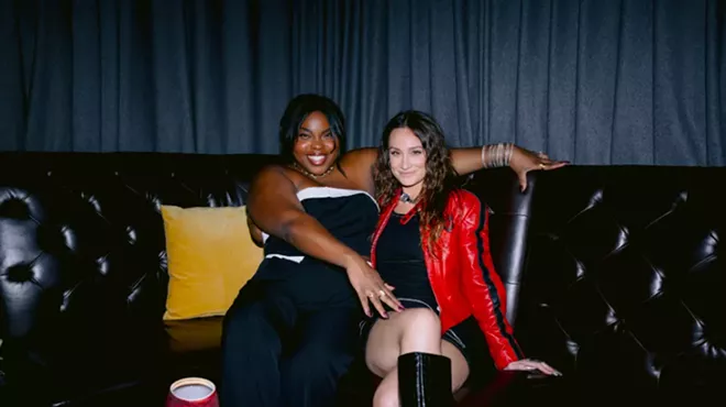 Karolena Theresa and Melissa Rich sitting on a couch
