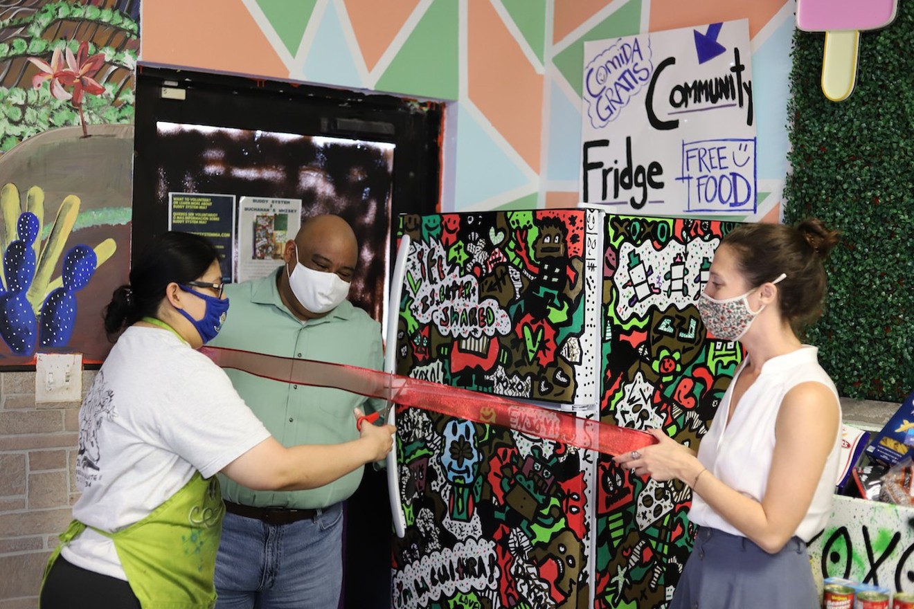 Buddy System activists Diana Resendiz, Gilberto Zepeda, and Kristin Guerin unveil a community fridge in Homestead.