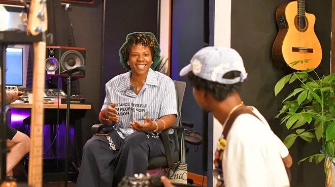two musicians working in a music studio