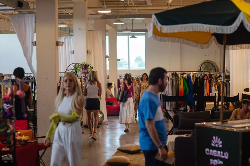 Image: guests walk around an indoor flea market