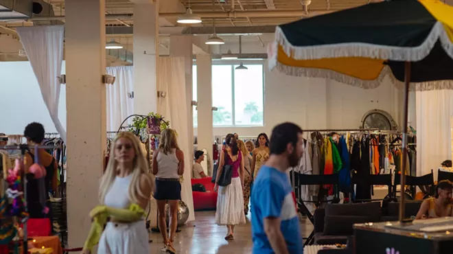 guests walk around an indoor flea market