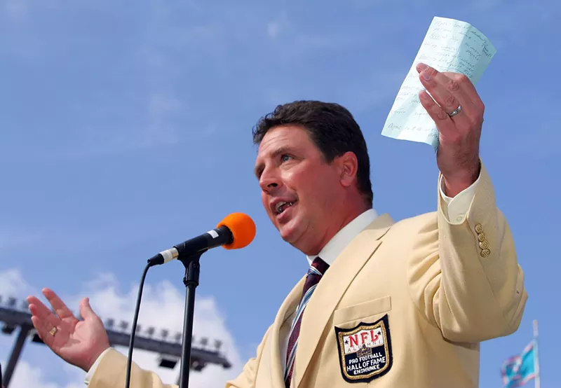 Image: Dan Marino gestures to the stadium crowd in Miami as he is honored for his induction into the Pro Football Hall of Fame during halftime of a game against the Atlanta Falcons in November 2005.
