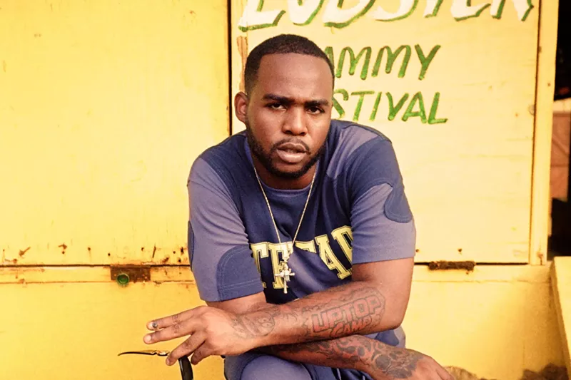 Image: Dancehall singer Teejay with his arms cross against a yellow background