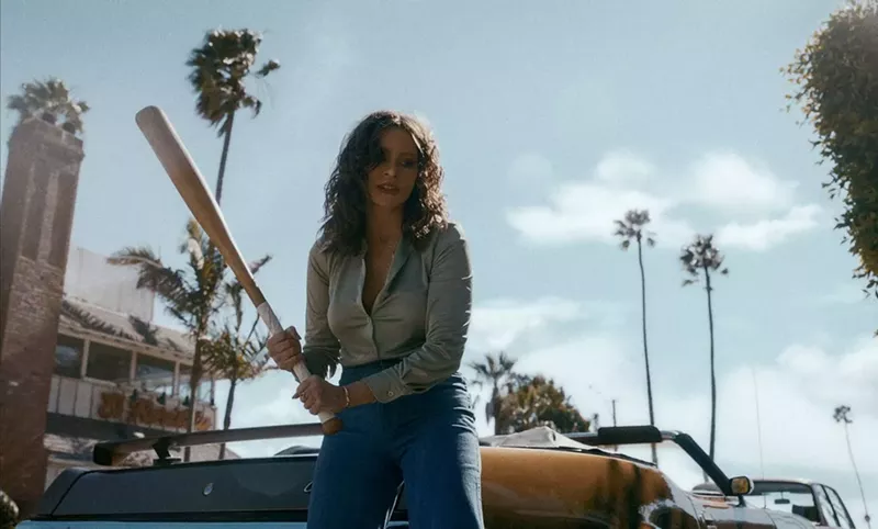 Image: Sofia Vergara's character in Griselda wields a baseball bat — with California palm trees in the background