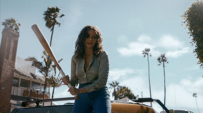 Sofia Vergara's character in Griselda wields a baseball bat — with California palm trees in the background