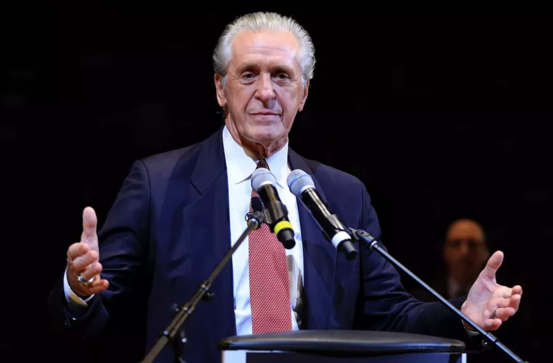 Image: Pat Riley stands in a suit in front of a podium
