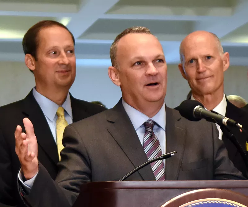 Image: Richard Corcoran speaks at the end of a special legislative session, flanked by Rick Scott (right) and Joe Negron (left), on June 9, 2017.