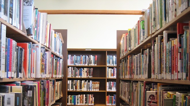 a photo of bookshelves in a library