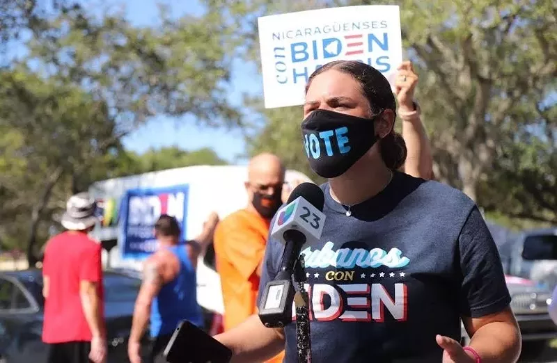 Image: Cubanos Pa'lante cofounder Daniela Ferrera speaks at a Cubanos Con Biden caravan event in 2020.