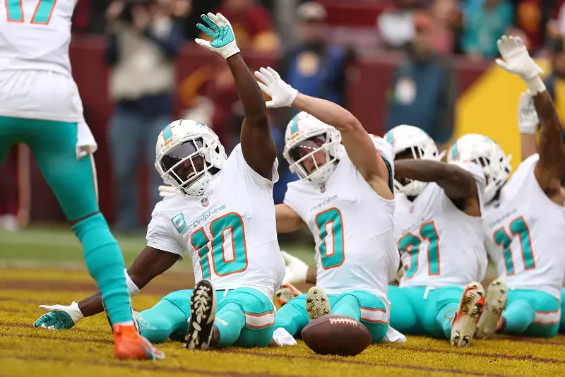 Image: The Miami Dolphins celebrate after a touchdown against the Washington Commanders at FedExField on December 03, 2023.