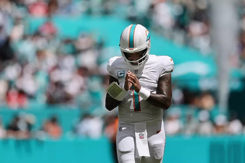 Image: Miami Dolphins quarterback Tua Tagovaiola strikes a prayer-like pose after his team scored a touchdown during the first half against the New England Patriots at Hard Rock Stadium in Miami Gardens on September 14, 2025.