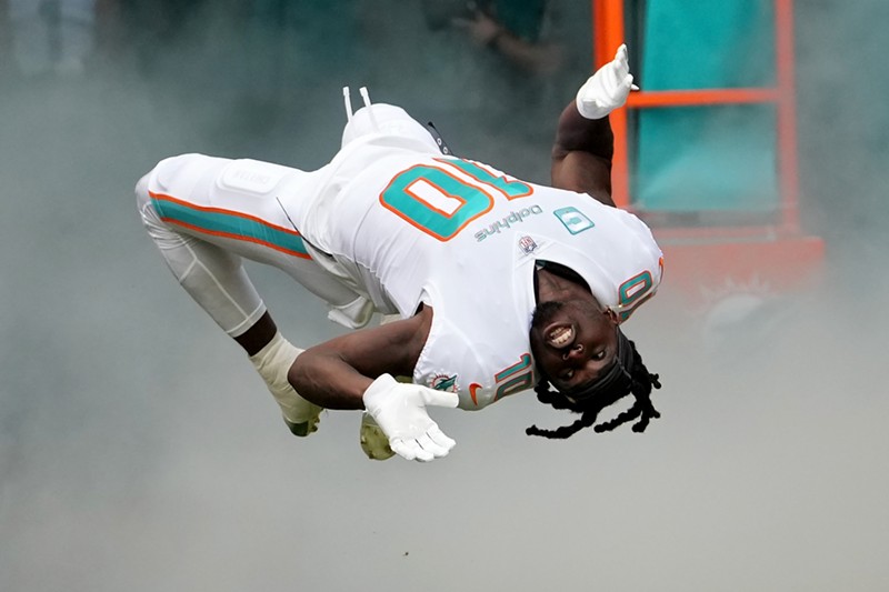 Tyreek Hill of the Miami Dolphins runs onto the field during player introductions on November 27, 2022 in Miami Gardens.