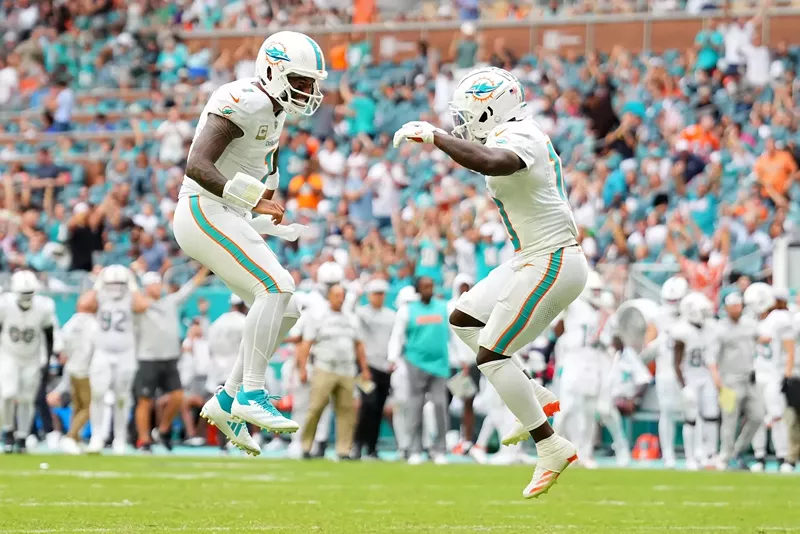 Image: Tua Tagovailoa #1 and Tyreek Hill #10 of the Miami Dolphins celebrate after their team's rushing touchdown in the fourth quarter of a game against the Las Vegas Raiders at Hard Rock Stadium on November 17, 2024, in Miami Gardens, Florida.