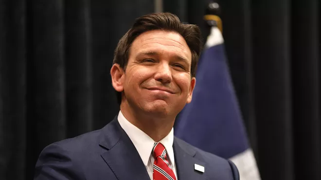 Florida Governor Ron DeSantis smiles for photographers.