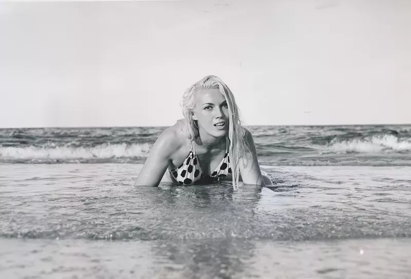 Image: Bunny Yeager crawling out of the ocean onto the shore