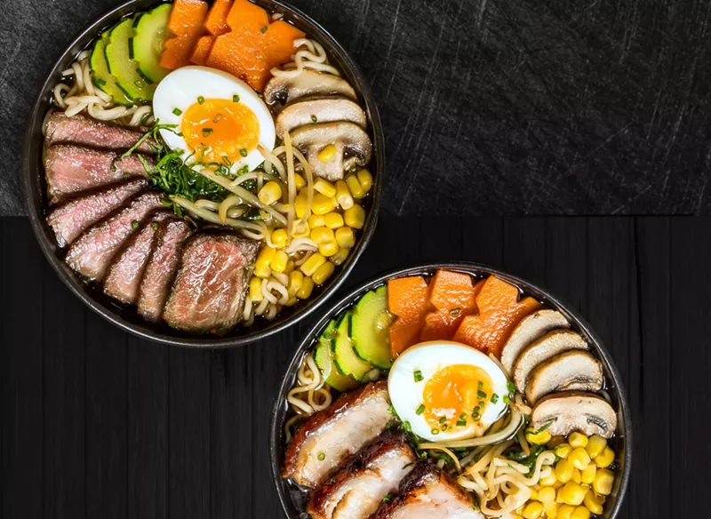Image: two ramen dishes on a black background