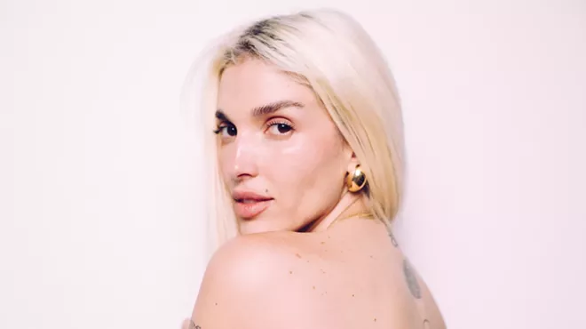 Portrait of a blonde woman with tattoos.
