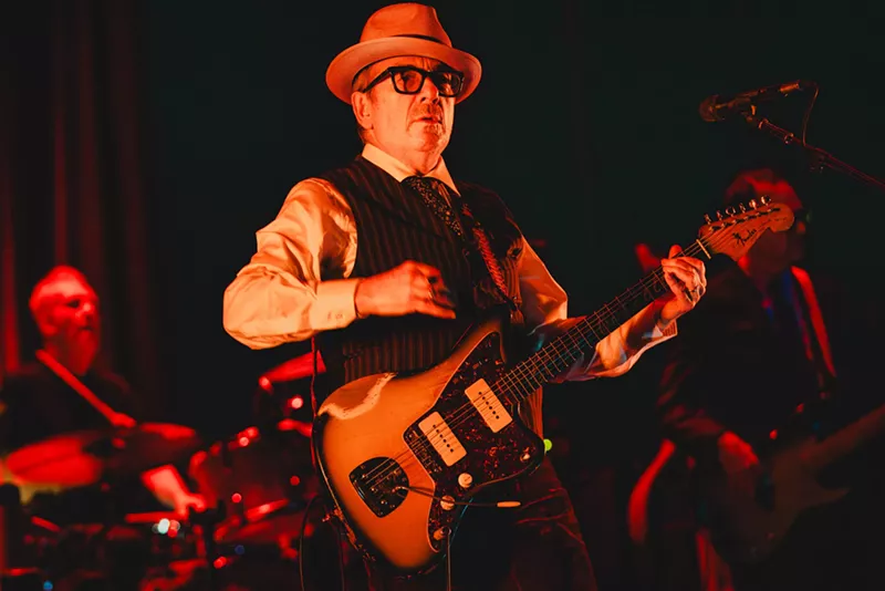 Image: Elvis Costello playing his guitar at a live show