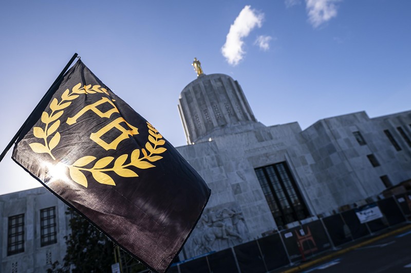 A Proud Boy flag flies in front of the Oregon state capitol during a protest in support of the January 6 attack on the U.S. Capitol.