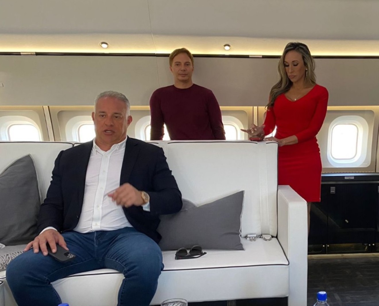 John Ruiz (seated) aboard a private plane during a 2022 New Times interview.