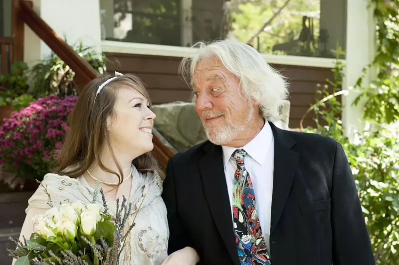Image: color stock photo of a young bride with an old bearded man