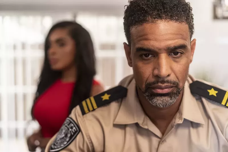 Image: Genji Jacques plays Lucias Goodman, the husband and father in The Sweetest Girl. Sandra Justice, in the background, plays his wife.
