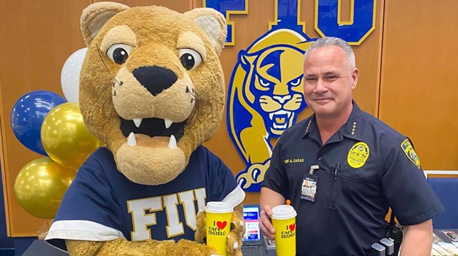 photo of uniformed campus police chief posing with FIU panther mascot. Both are holding large branded Cafe Bustelo disposable coffee cups.