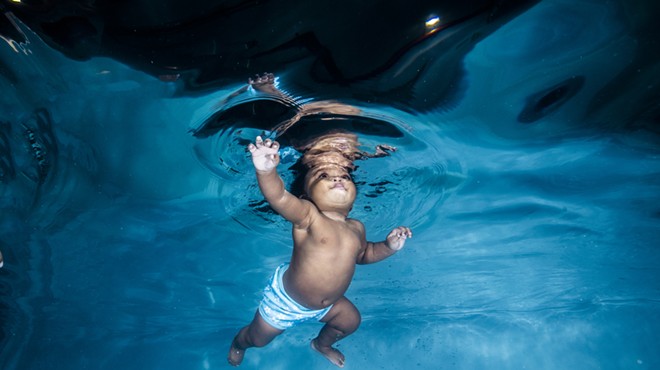 Underwater shot of a toddler swimming in a pool