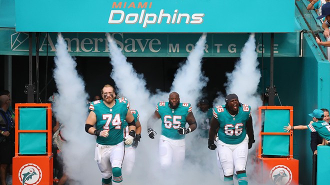 The Miami Dolphins trot onto their home field in Miami Gardens before a game